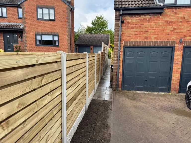 Horizontal Slatted Fence Alongside Driveway by Sheffield Fencing